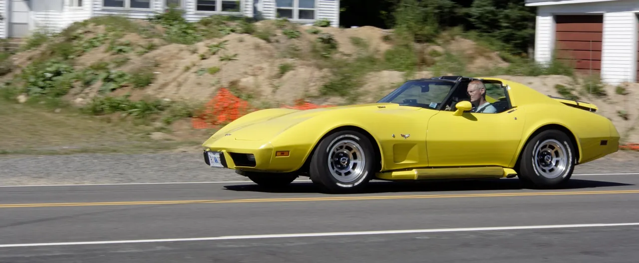 Binnie driving his yellow C3 Corvette