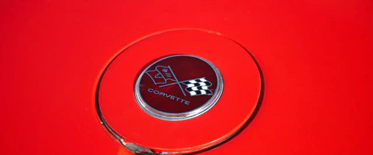 Red Corvette nose with chrome crossed-flags emblem