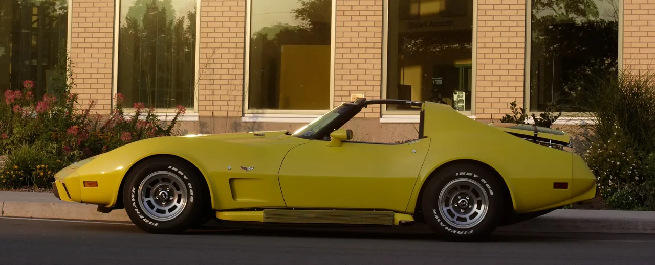 Yellow C3 Corvette in golden evening light