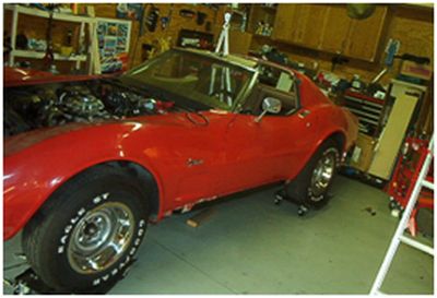 Corvette body lowered back onto the repaired frame