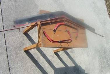 Four pieces of bumper mounting hardware removed from the old cover