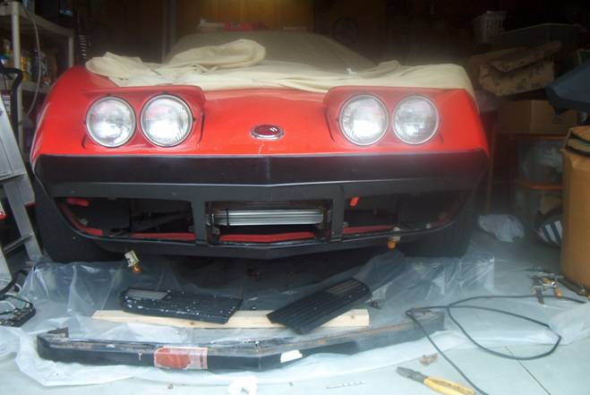 New fiberglass bumper cover fitted and bolted to the car, ready for paint