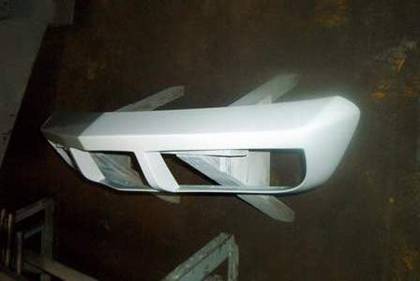 Block sanding the fiberglass bumper cover with dry sandpaper
