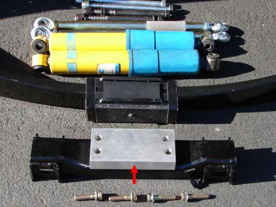 Aluminium spacer fitted between the strut bracket and the differential
