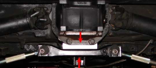 Red arrows pointing at the fitted aluminium spacer