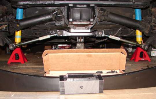 New TRW spring on the floor under the car, ready to be installed