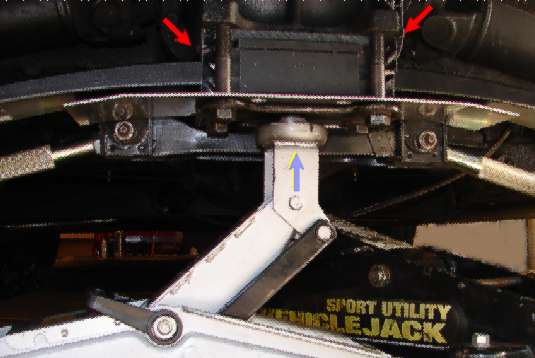 Jack holding the centre of the new spring while starting the four bolts