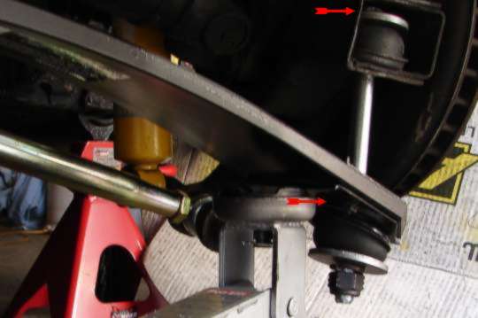 Red arrows showing where the long spring bolt goes through