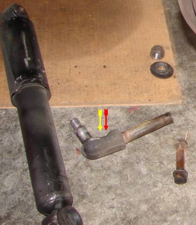 The L-shaped bolt that carries both shock and strut